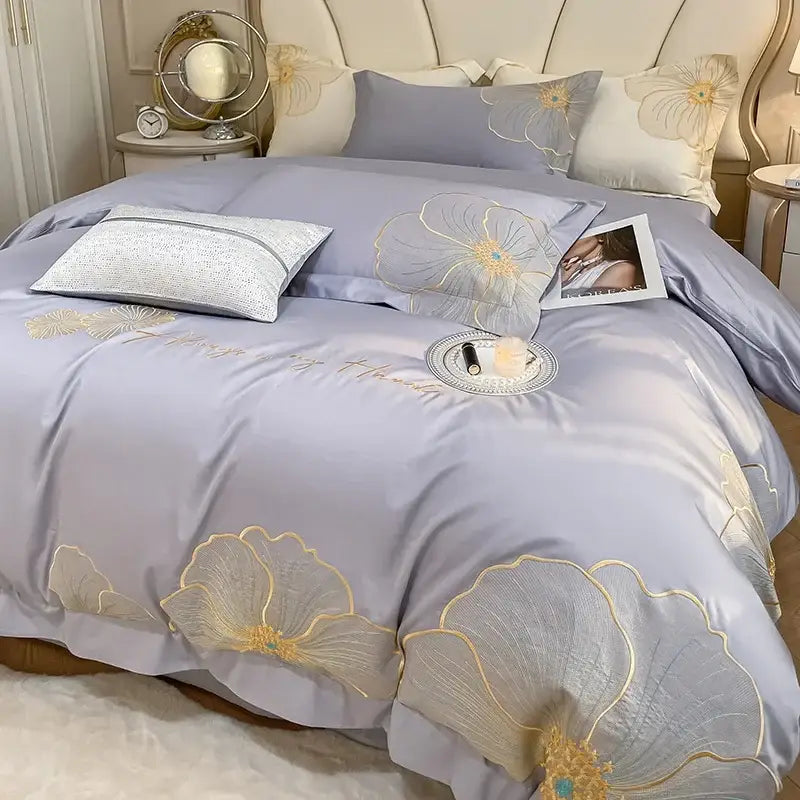 Lavender satin duvet cover set with gold-threaded floral embroidery and matching pillowcases in embroidered egyptian cotton bedding set