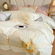Elegant ivory satin duvet cover with intricate floral embroidery in gold blue and orange in egyptian cotton bedding set
