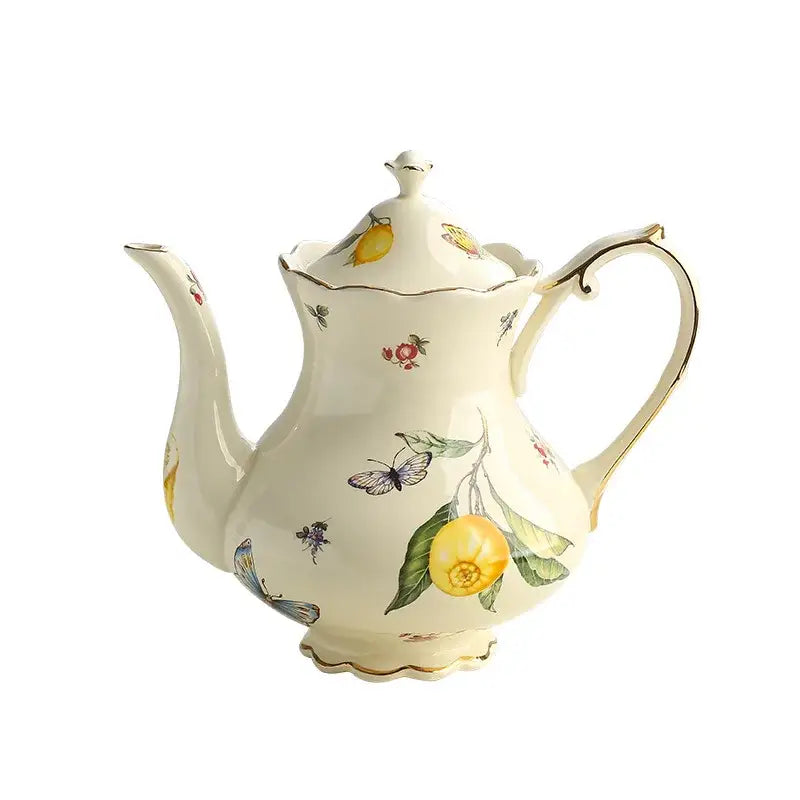 Cream-colored porcelain tea set teapot with hand-painted lemon and butterfly motifs and gold trim accents