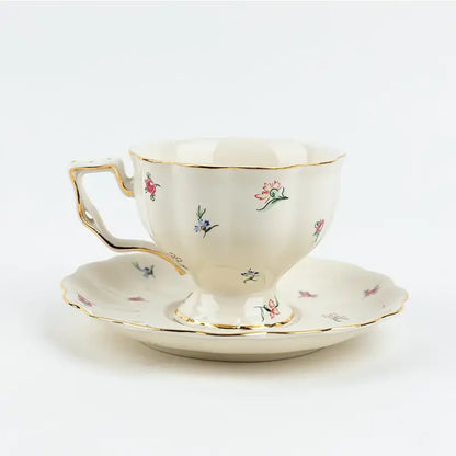 Cream-colored porcelain tea set with delicate pink blue green floral patterns and gold trim for elegant dining room use