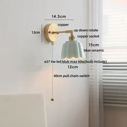 Floral light blue glass wall light fixture with a delicate ceramic lampshade and copper finish for bedroom use