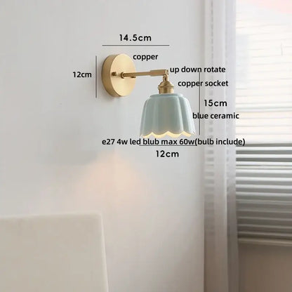 Delicate blue ceramic wall light fixture with fluted petal design and copper mounting hardware for bedroom use
