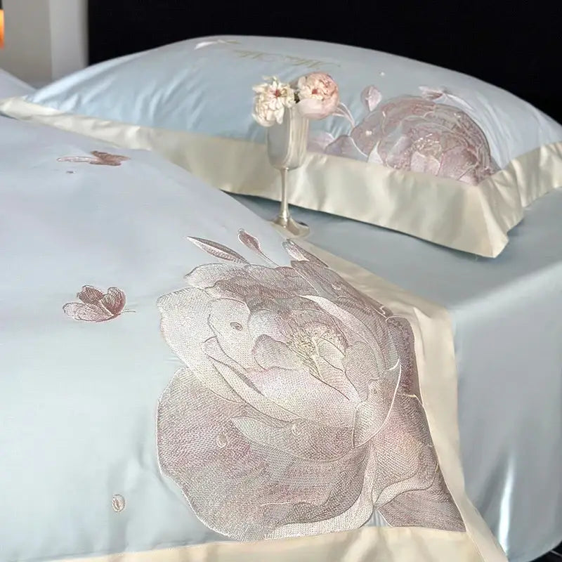 Light blue satin bedding set with intricate rose and butterfly embroidery in metallic silver thread by decorbites 1000tc egyptian cotton
