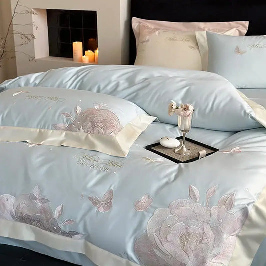 Light blue satin bedding set with intricate pink and silver floral embroidery made of decorbites 1000tc egyptian cotton