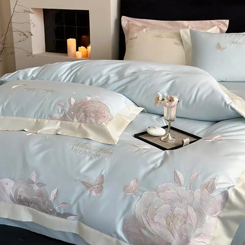 Light blue satin bedding set with intricate pink and silver floral embroidery made of decorbites 1000tc egyptian cotton