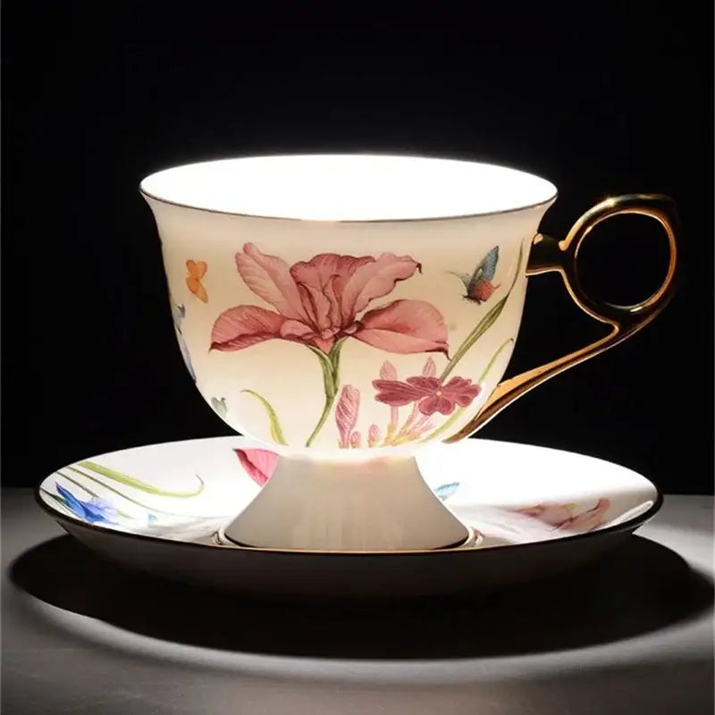 Delicate porcelain lily flower tea set with gold rim featuring hand-painted pink flowers and butterflies on creamy white glaze