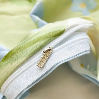 Gold-toned zipper pull with textured grid pattern on white edge of floral mint green cotton duvet cover decorbites cotton duvet