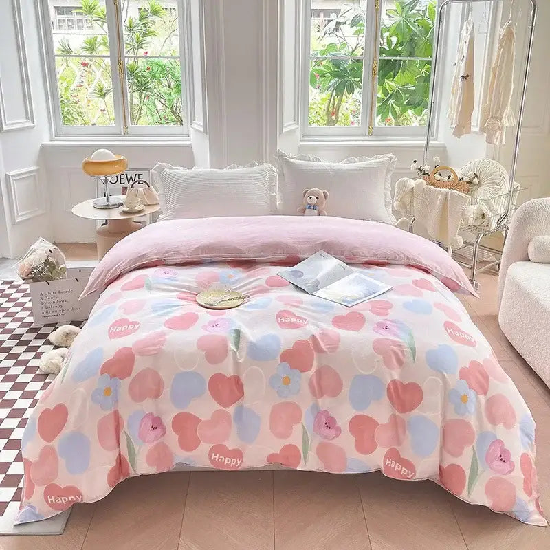 Pink floral comforter with pastel hearts and happy text made of soft cotton in a floral mint green cotton duvet cover set