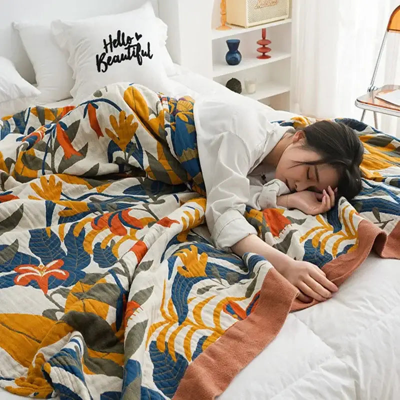 Cozy cotton throw blanket with bold orange blue and green floral leaves on cream and terracotta border decorbites cotton throw