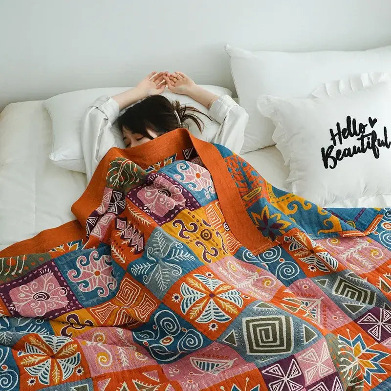 Vibrant floral mustard and white decorbites cotton throw blanket with bold geometric and floral patterns in orange and blue hues