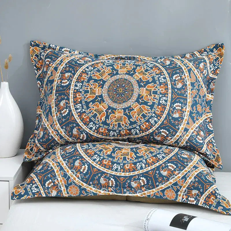 Blue and orange mandala-patterned pillowcases with intricate elephant designs complement floral navy and orange decorbites cotton picnic blanket bedspread