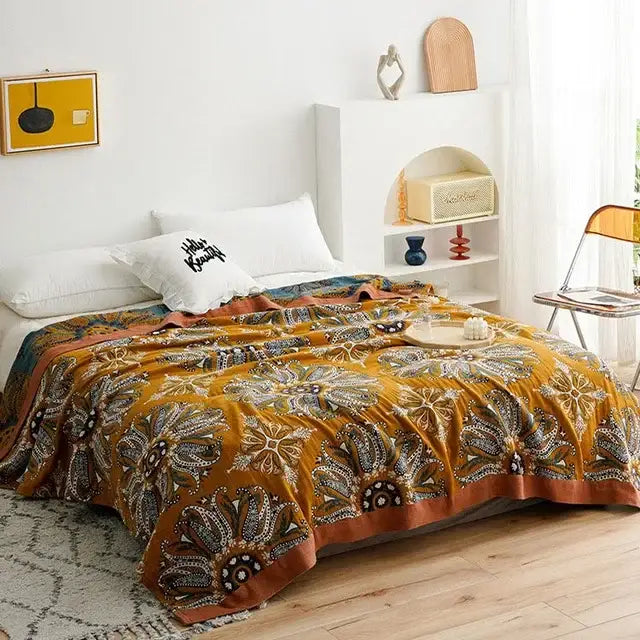 A mustard-yellow decorbites cotton summer throw blanket with floral and paisley patterns for bedroom decor