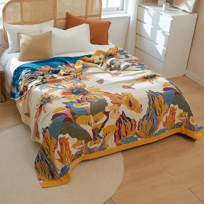 A vibrant floral orange and blue cotton summer throw blanket with bold sunflowers on cream decorbites cotton summer decor