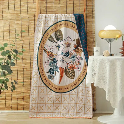 A cream quilted cotton gauze adult bath towel with floral motifs and embroidered decorbites cotton gauze border decor