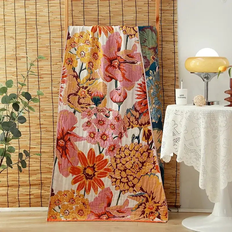 Vibrant floral-patterned cotton gauze adult bath towel with bold orange pink and yellow blossoms for decorbites bath towels