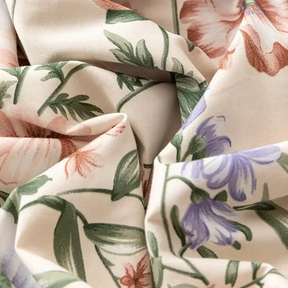 Soft cream-colored bedding set with delicate pink purple floral pattern made of decorbites 100s egyptian cotton