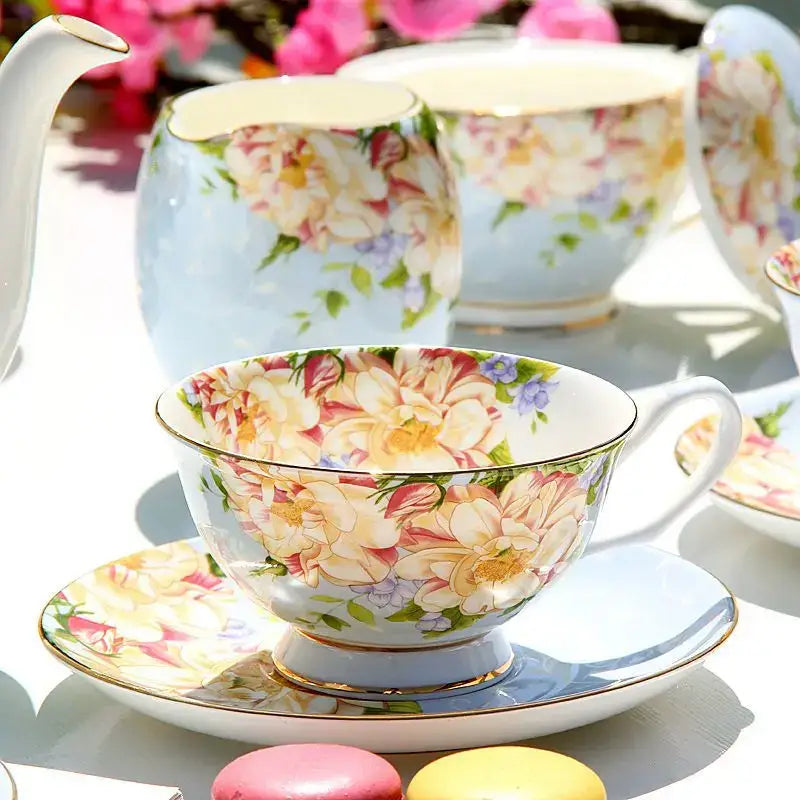 A delicate porcelain tea set cup with peach cream roses and purple blossoms for decorbites ceramic afternoon tea