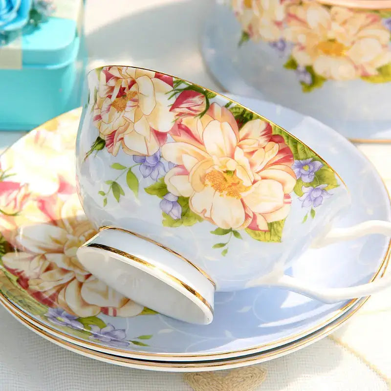 Floral pastel porcelain tea set featuring a delicate blue glazed afternoon tea cup with floral patterns and gold trim decorbites ceramic afternoon