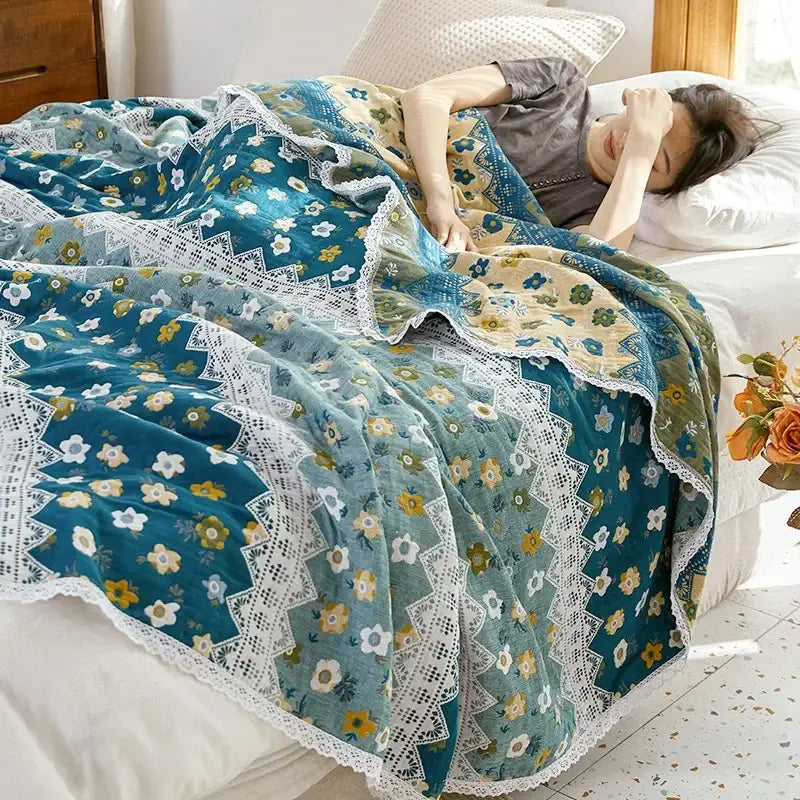 A soft teal and cream floral sofa cover with delicate white lace trim made of decorbites breathable cotton gauze