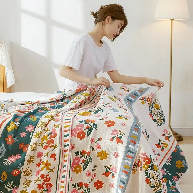 A woman holds a vibrant floral patchwork breathable cotton gauze sofa cover for living room decor