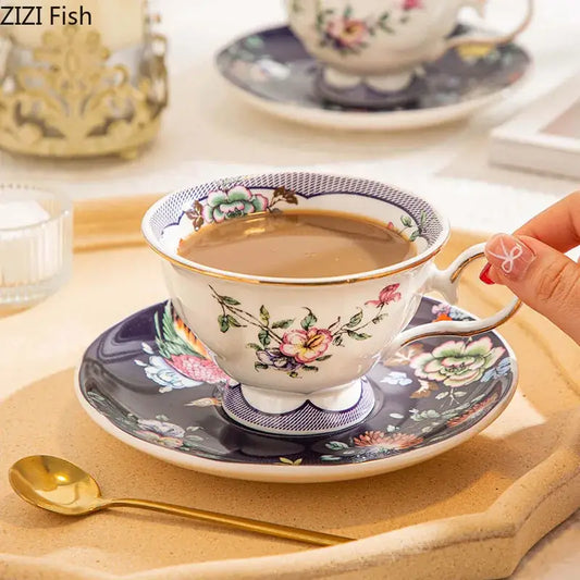 A delicate ceramic cup with decorbites flowers pattern in pink green and yellow with gold trim for dining room use