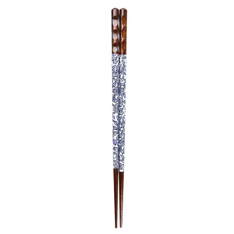 A pair of bamboo wood chopsticks with white and blue floral patterns and dark brown ends for enhanced dining experience