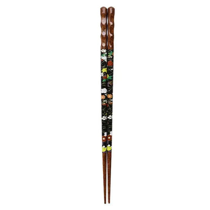 A pair of dark brown bamboo wood chopsticks with black lacquer and intricate floral patterns in a dining gift box