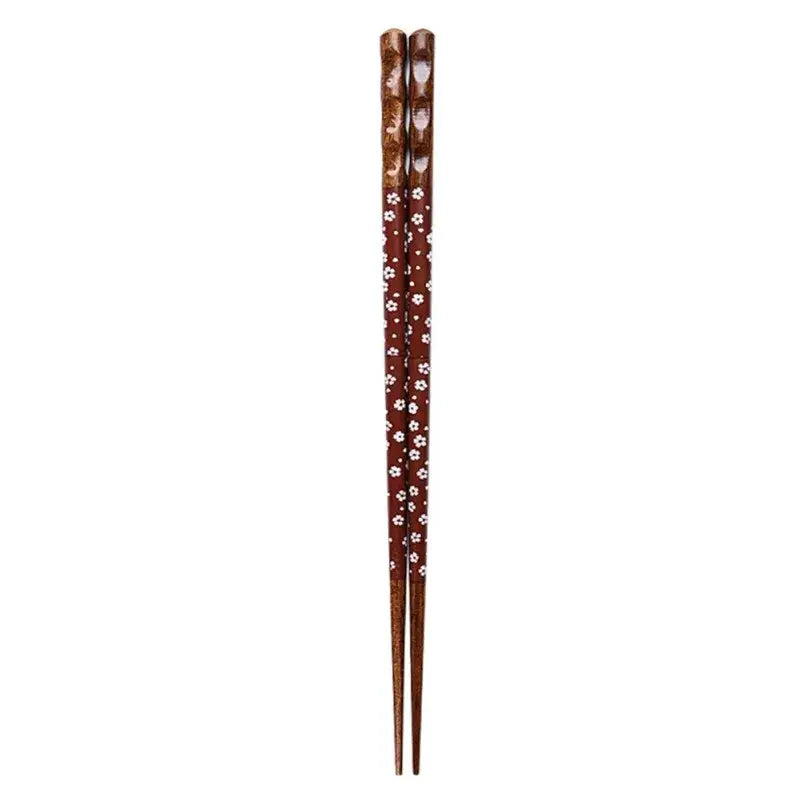 A pair of brown bamboo wood chopsticks with a delicate white floral pattern for an enhanced dining experience