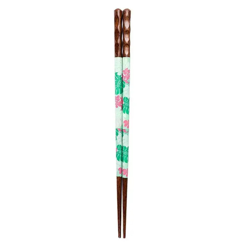 A pair of bamboo wood chopsticks with floral patterned light mint green body and dark brown textured handles in gift box