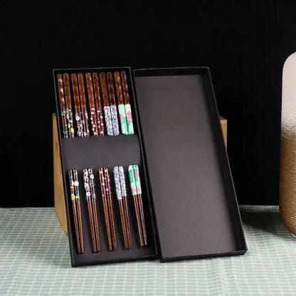 Set of floral patterned bamboo wood chopsticks in a sleek black gift box for enhanced dining experience