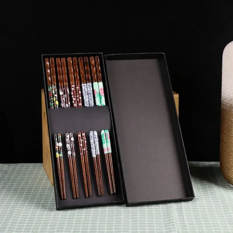 Set of floral patterned bamboo wood chopsticks in a sleek black gift box for enhanced dining experience
