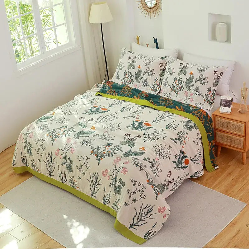 Botanical-patterned decorbites cotton gauze towel blanket with cream base green orange floral motifs and lime-green border