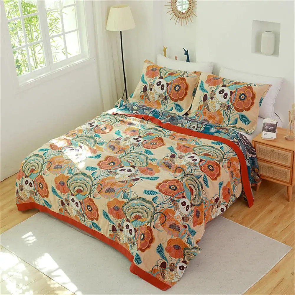 Beige and orange floral-patterned decorbites cotton gauze towel blanket with panda motifs and vibrant border trim