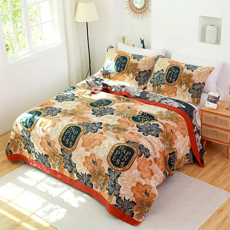 A cozy floral-patterned cotton gauze towel blanket in warm orange cream with dark green leaves by decorbites cotton gauze