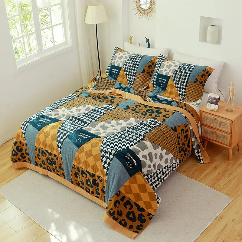 A cozy cotton gauze towel blanket with bold leopard print, navy houndstooth, and orange geometric designs by decorbites