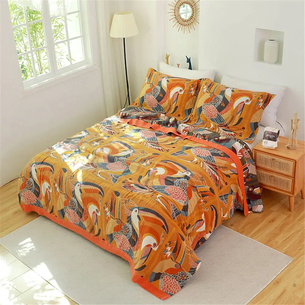 Floral pink and blue cotton gauze towel blanket featuring a vibrant orange multicolored toucan-patterned decorbites cotton gauze design