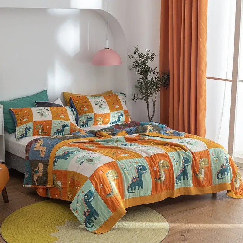A vibrant orange and teal dinosaur-themed quilt set made of soft cotton gauze towel cotton gauze towel blanket decorbites cotton gauze