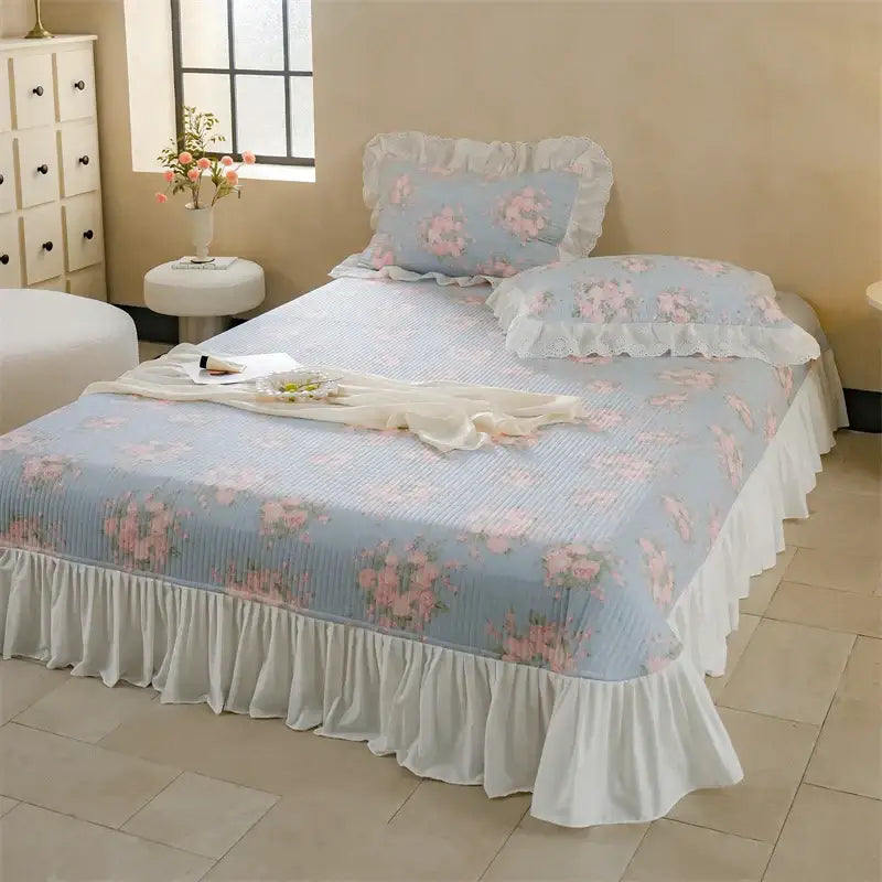 Light blue floral quilted bedspread set with pink blossoms and white ruffled edges for bedroom decor