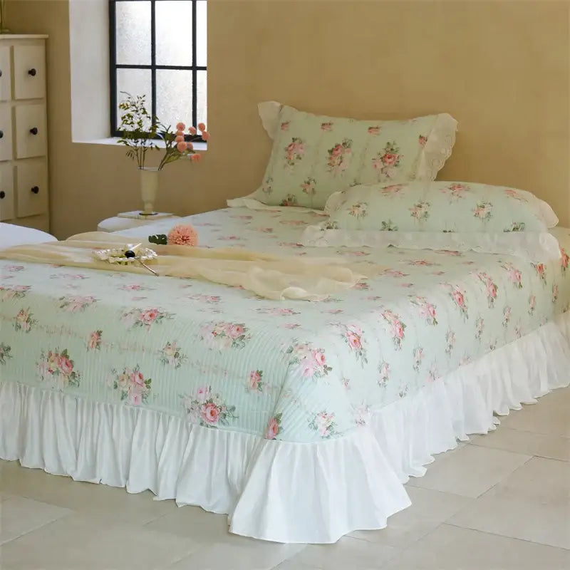 Light green floral quilted bedspread set with pink roses and white ruffled trim for bedroom decor