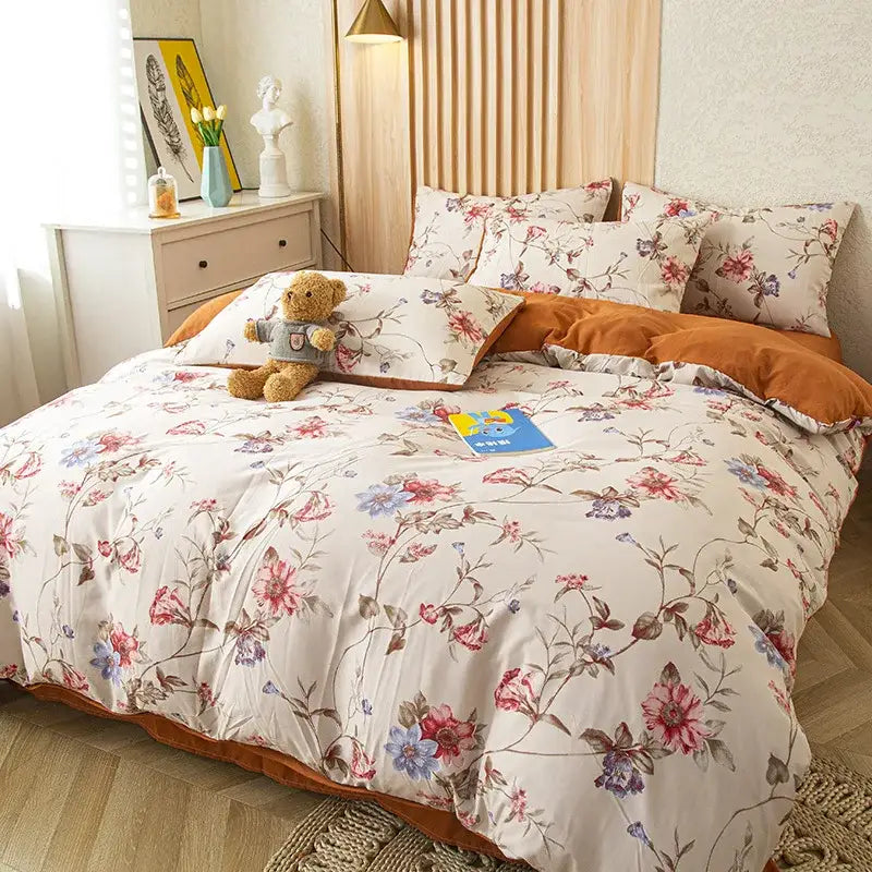 Floral pink and blue flower print bedding set with delicate blossoms on cream soft cotton for bedroom use