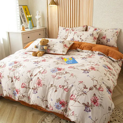 Floral pink and blue flower print bedding set with delicate blossoms on cream soft cotton for bedroom use