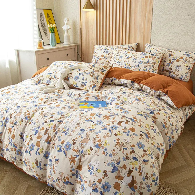 Cream-colored soft cotton bedding set with embroidered bunny and flower print in blue brown and yellow tones
