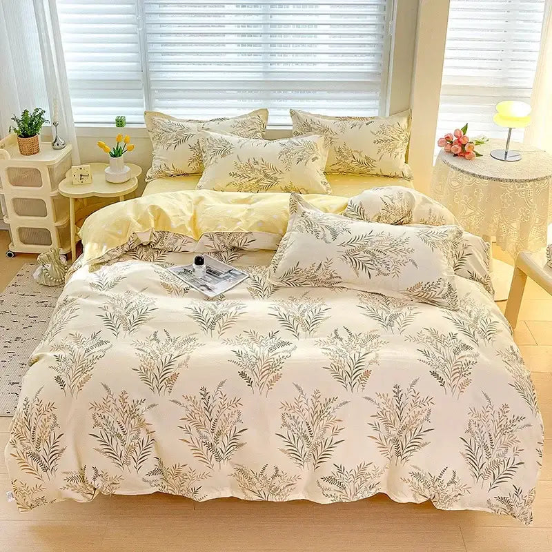 Cream-colored decorbites cotton printed bedding set with delicate green and beige botanical print featuring matching pillows