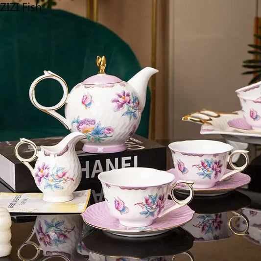 Elegant porcelain coffee mug set with floral pink and purple patterns and gold-trimmed handles and rims