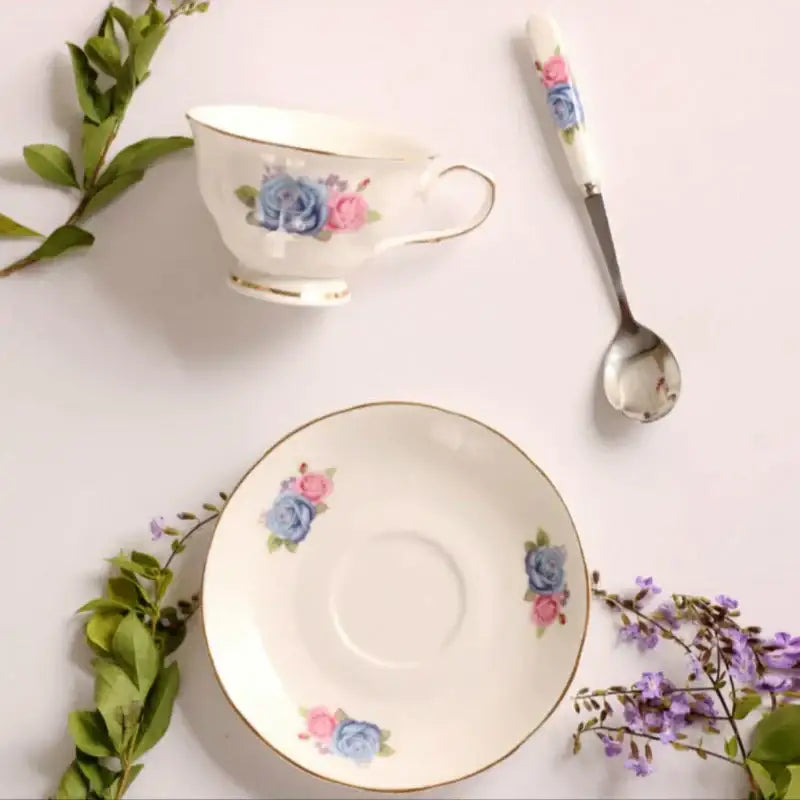 White porcelain tea cup set with delicate blue and pink floral patterns and gold trim for dining room coffeeware