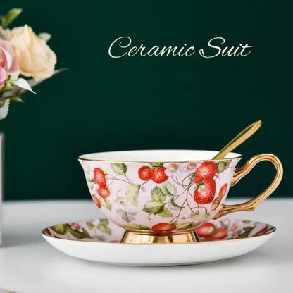 Floral pink and purple porcelain tea cup set with gold trim and strawberry pattern perfect for dining room or coffeeware use