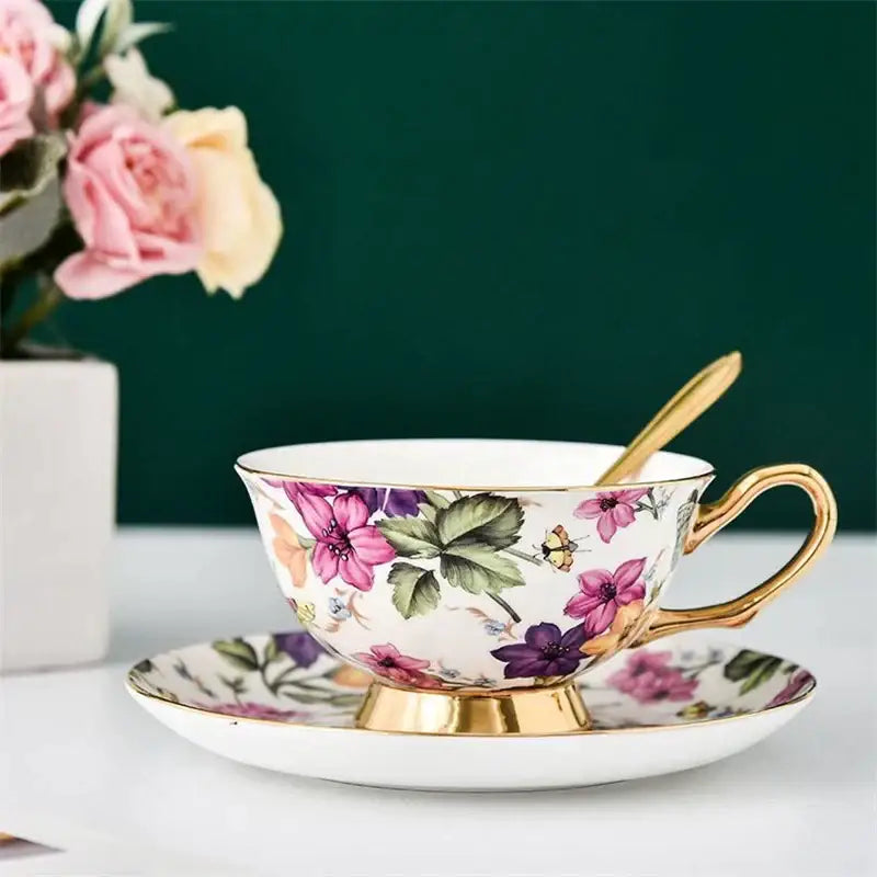 Delicate porcelain tea cup set with vibrant floral pink purple pattern and gold trim for dining and coffeeware use