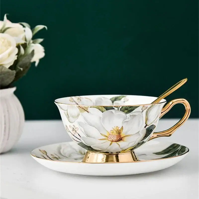 Elegant white porcelain tea cup set with gold trim and delicate magnolia flower design for dining room use