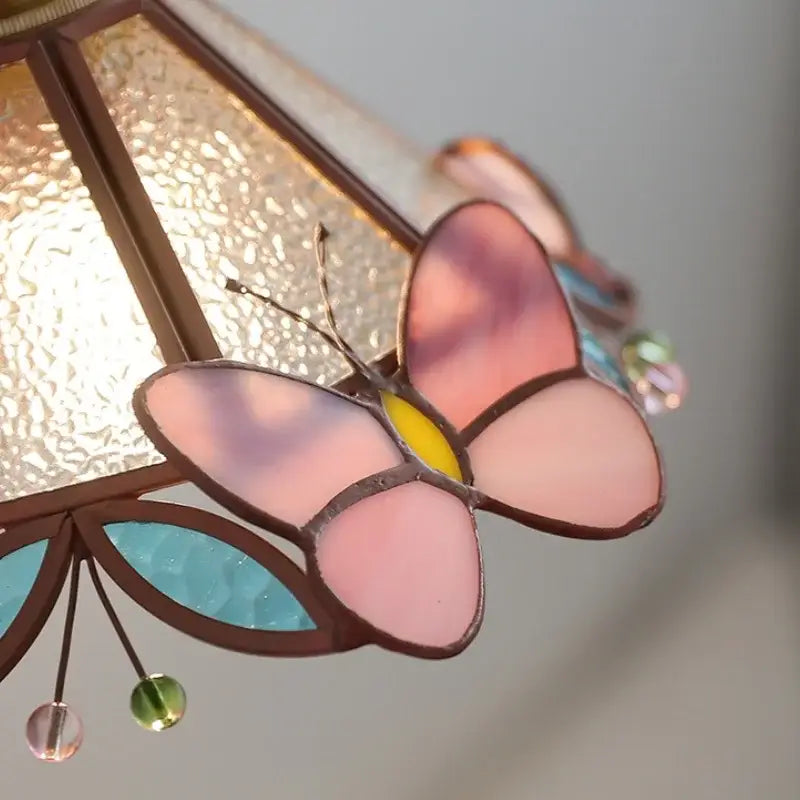 Delicate pink and yellow stained glass decorbites butterfly glass wall with turquoise leaves and colorful bead accents wall light