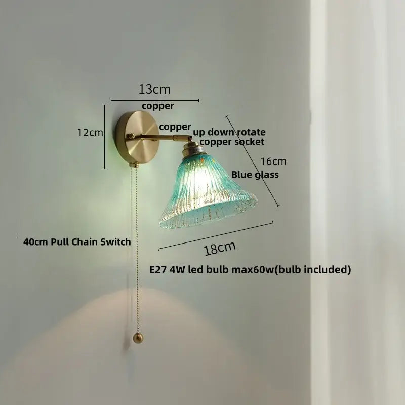 A vintage-style wall light with copper mount and elegant blue decorbites butterfly glass shade for bedroom use